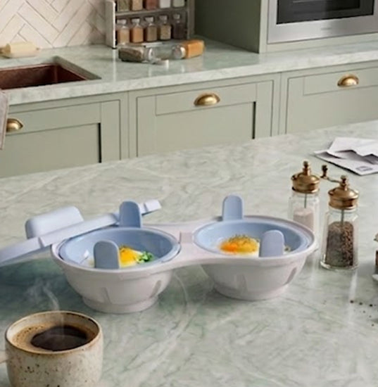 Electric peeler tool on a kitchen counter with freshly peeled fruits and vegetables and prep ingredients.